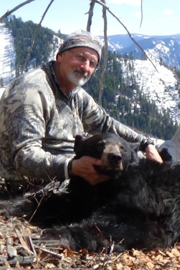 Joe holding black bear 