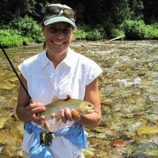 Woman holding caught fish