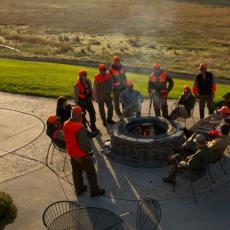 Group of hunters around a campfire