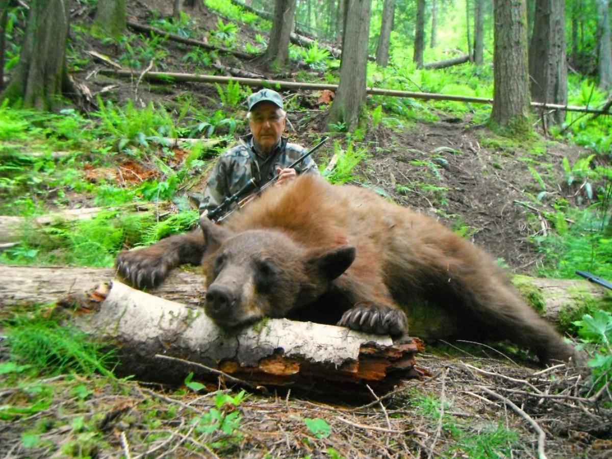 Flying B Ranch hunter with bear, wet wade fishing