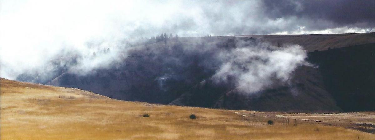 Clouds moving through a valley